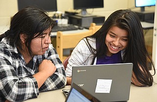 Staff photo / Gasive Aguilar, right, and Alicia Bautista work on a computer in 2015 during a Tech Goes Home class at East Lake Academy. The digital training program, which offers discounted computers for graduates, received state grants of nearly $2 million to expand its programs over 10 counties in Southeast Tennessee over the next two years.